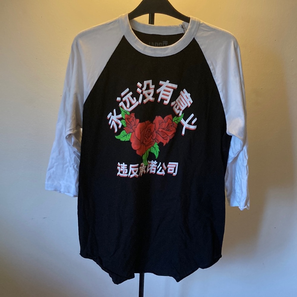 Black and white baseball style shirt with writing and roses. M